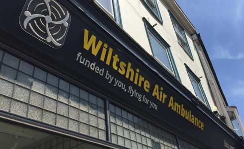 Wiltshire Air Ambulance's Devizes charity shop signage with yellow and white writing Wiltshire Air Ambulance's Devizes charity shop signage with yellow and white writing