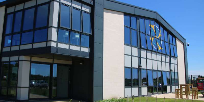 A photo of the front aspect of the Wiltshire Air Ambulance airbase against a sunny blue background.