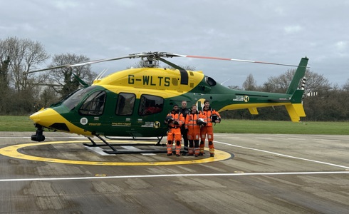 Wiltshire and Bath Air Ambulance Charity's new look helicopter, back at it's airbase in Semington, with four members of the critical care team standing beside it