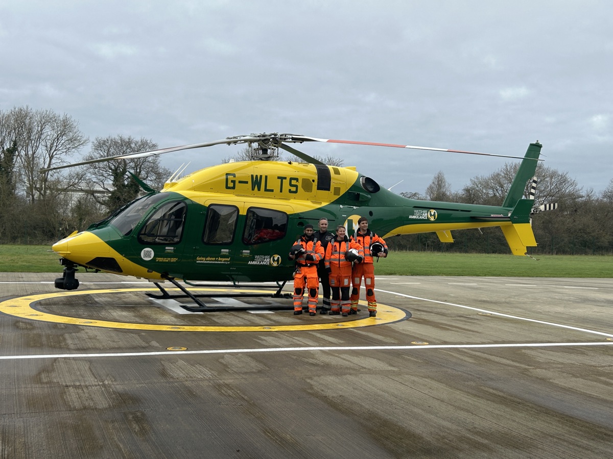 Wiltshire and Bath Air Ambulance Charity's new look helicopter, back at it's airbase in Semington, with four members of the critical care team standing beside it