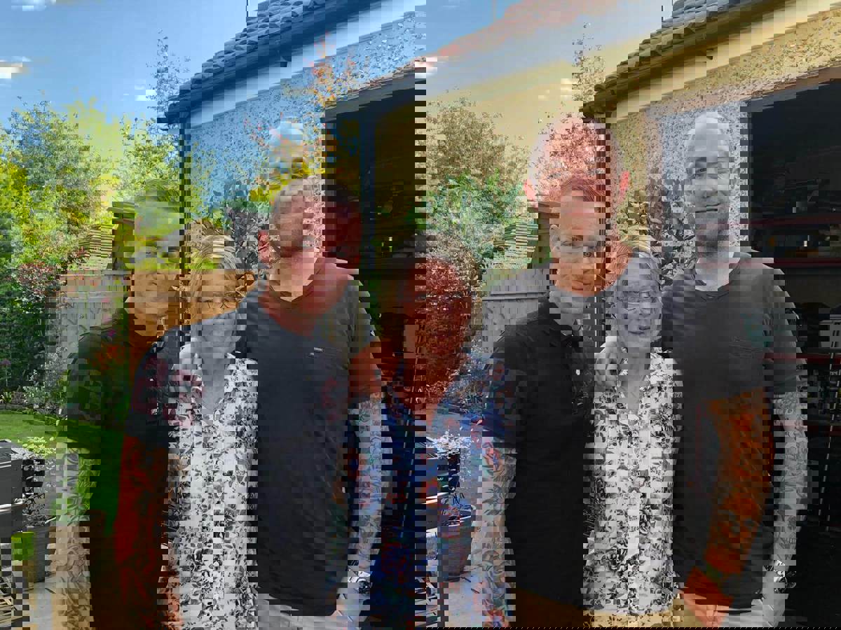 A former patient with their two children stood in a garden A former patient with their two children stood in a garden