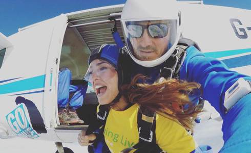 Fundraiser taking part in a skydive, wearing a Wiltshire Air Ambulance yellow t-shirt