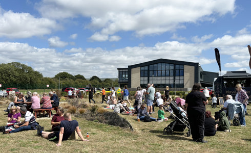 A group of people lounging in the sun at an air ambulance airbase