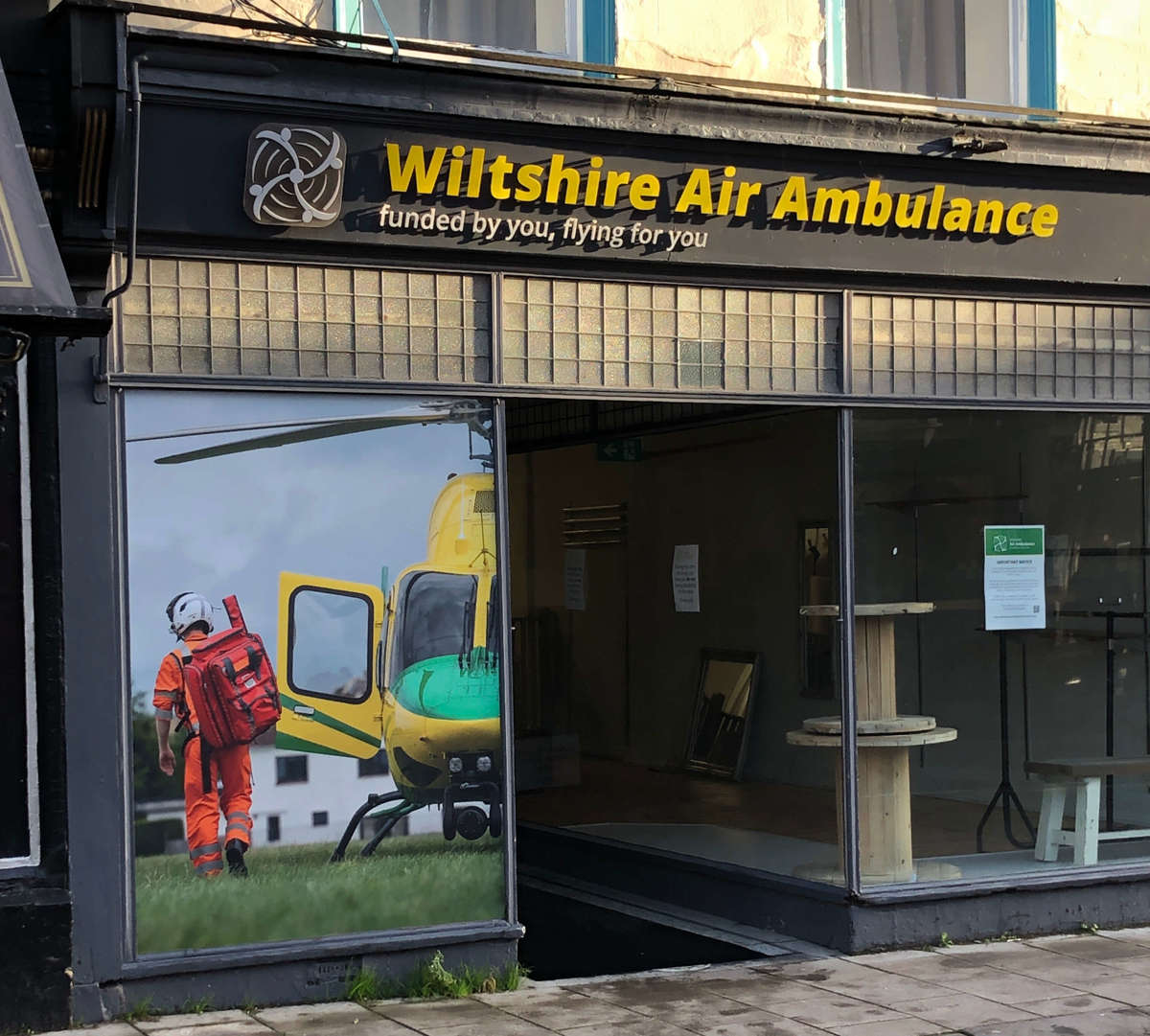 The WAA charity shop window with new vinyl sticker.