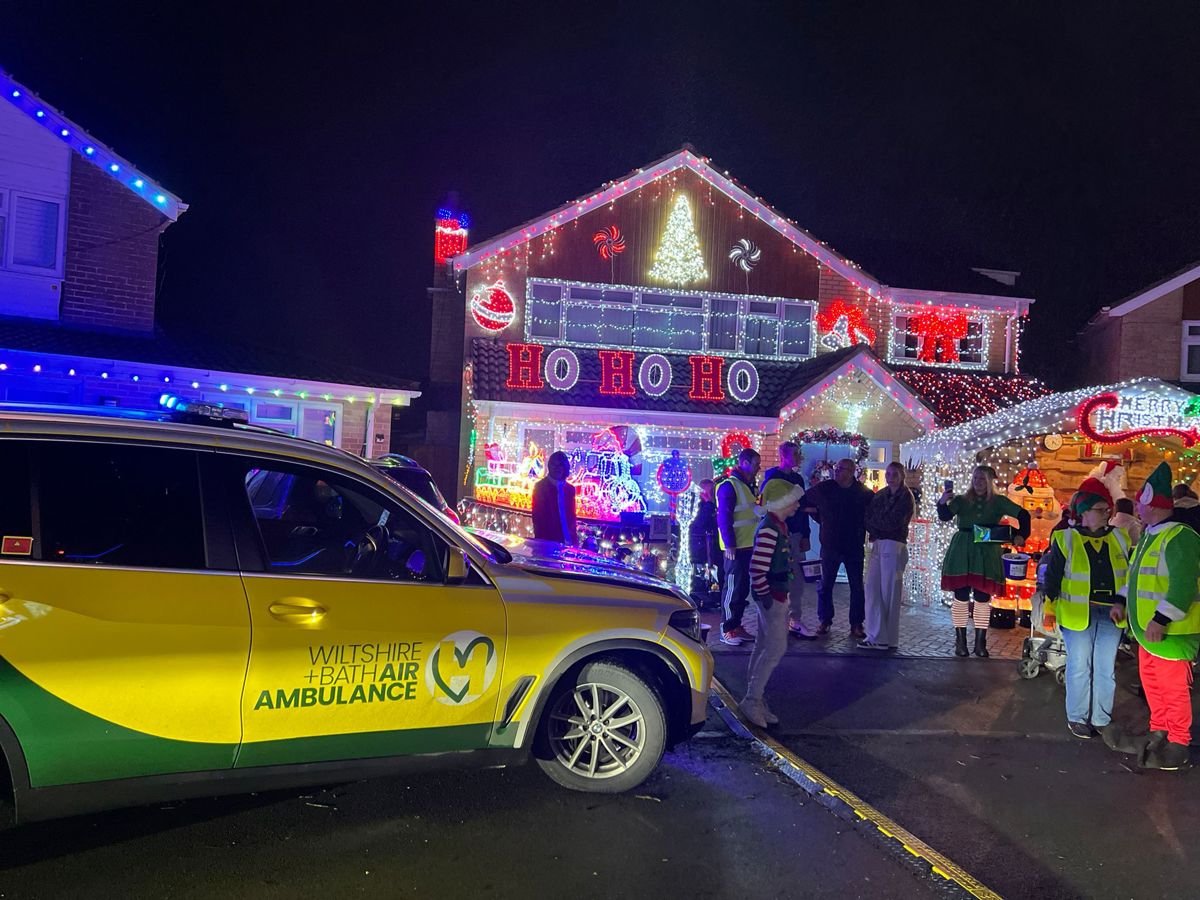 Yellow and green Wiltshire and Bath Air Ambulance critical care car at Sarum Avenue Christmas lights in Melksham