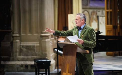 TV's Paul Martin speaking to a crowd from a pulpit