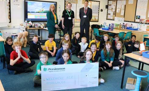 Persimmon Homes Wessex hand over a £5,000 cheque to Wiltshire Air Ambulance at Castle Mead School, Trowbridge