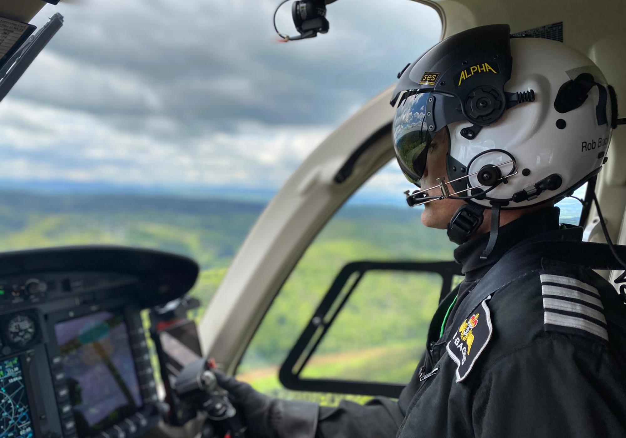 Pilot Rob wearing flight helmet, flying Wiltshire Air Ambulance's helicopter